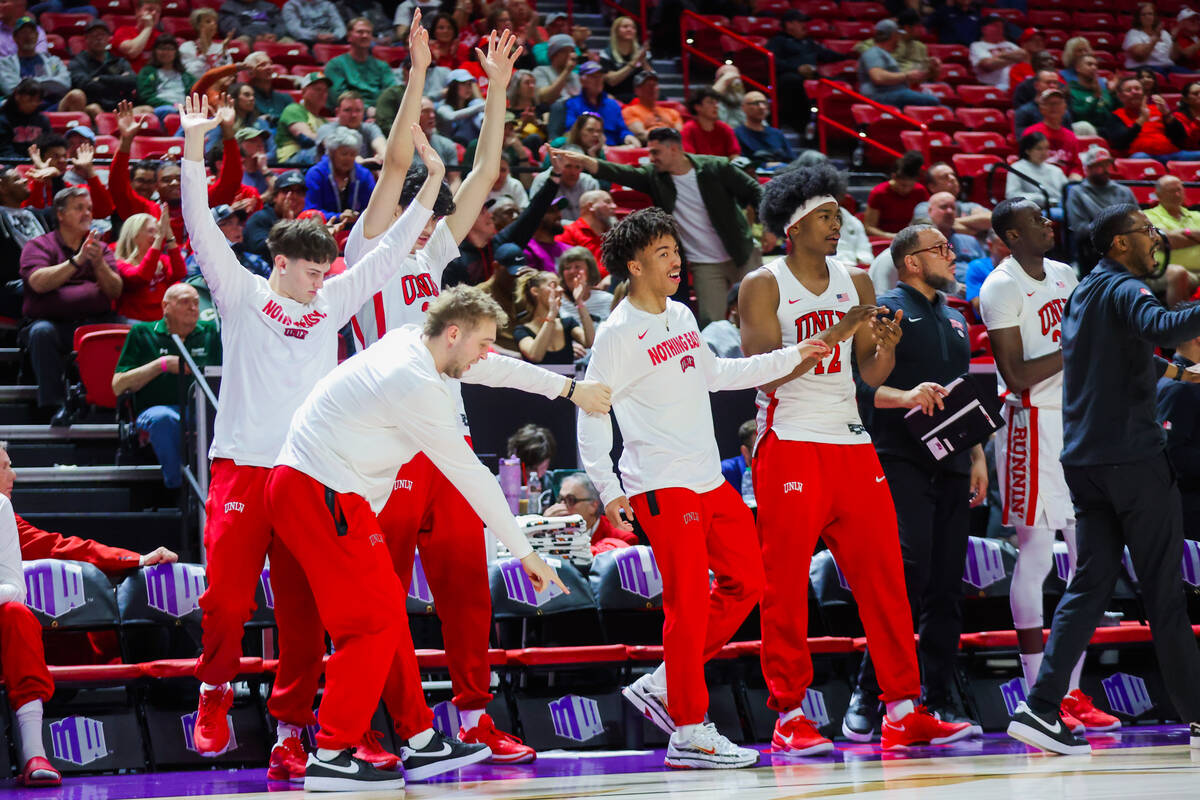 The Rebels bench celebrates during a Mountain West men’s tournament NCAA basketball game ...