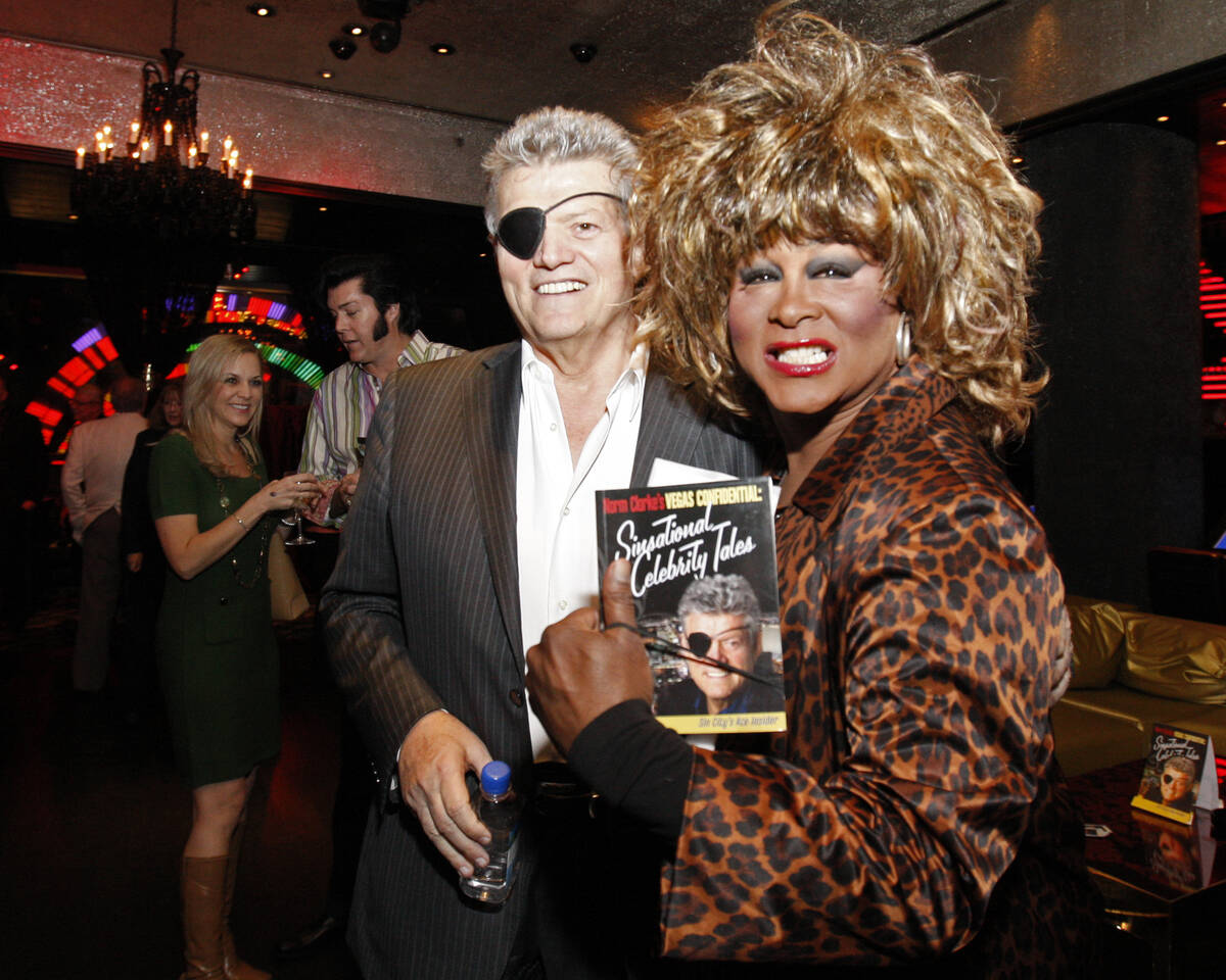 Las Vegas Review-Journal columnist Norm Clarke, left, stands with female impersonator Larry Edw ...