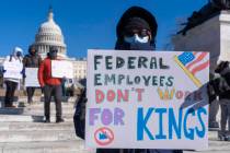 A federal employee, who asked not to use their name for fears over losing their job, protests w ...