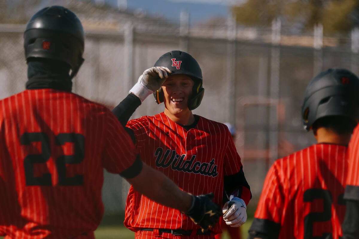Las Vegas’ Hunter Iverson (18) jogs into home, greeting his teammates after hitting a gr ...