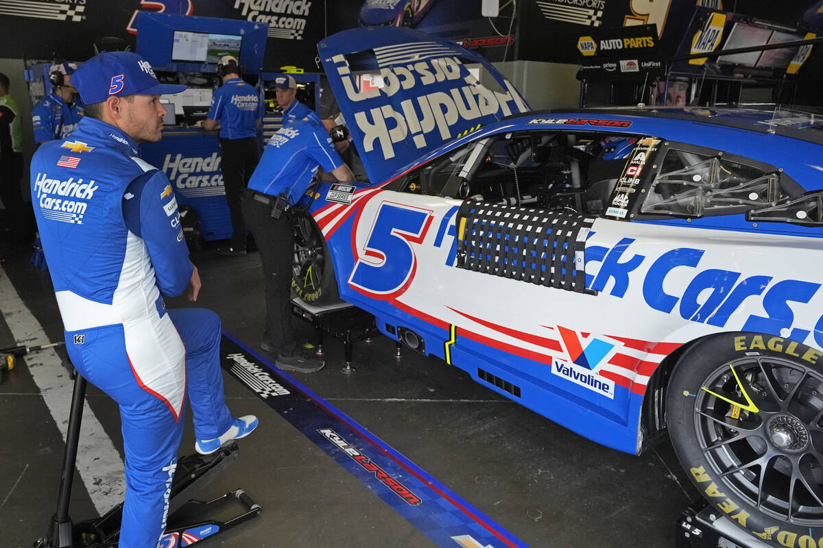 Kyle Larson waits while his crew makes adjustments to his car during a practice session for the ...