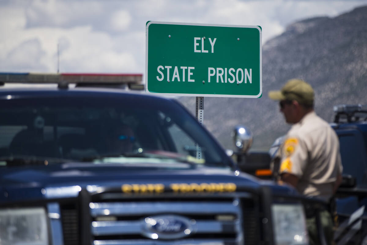 Law enforcement officials guard the entrance to Ely State Prison in Ely in July 2018. (Chase St ...