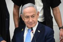 Israel's Prime Minister Benjamin Netanyahu, attends his trial on corruption charges at the dist ...