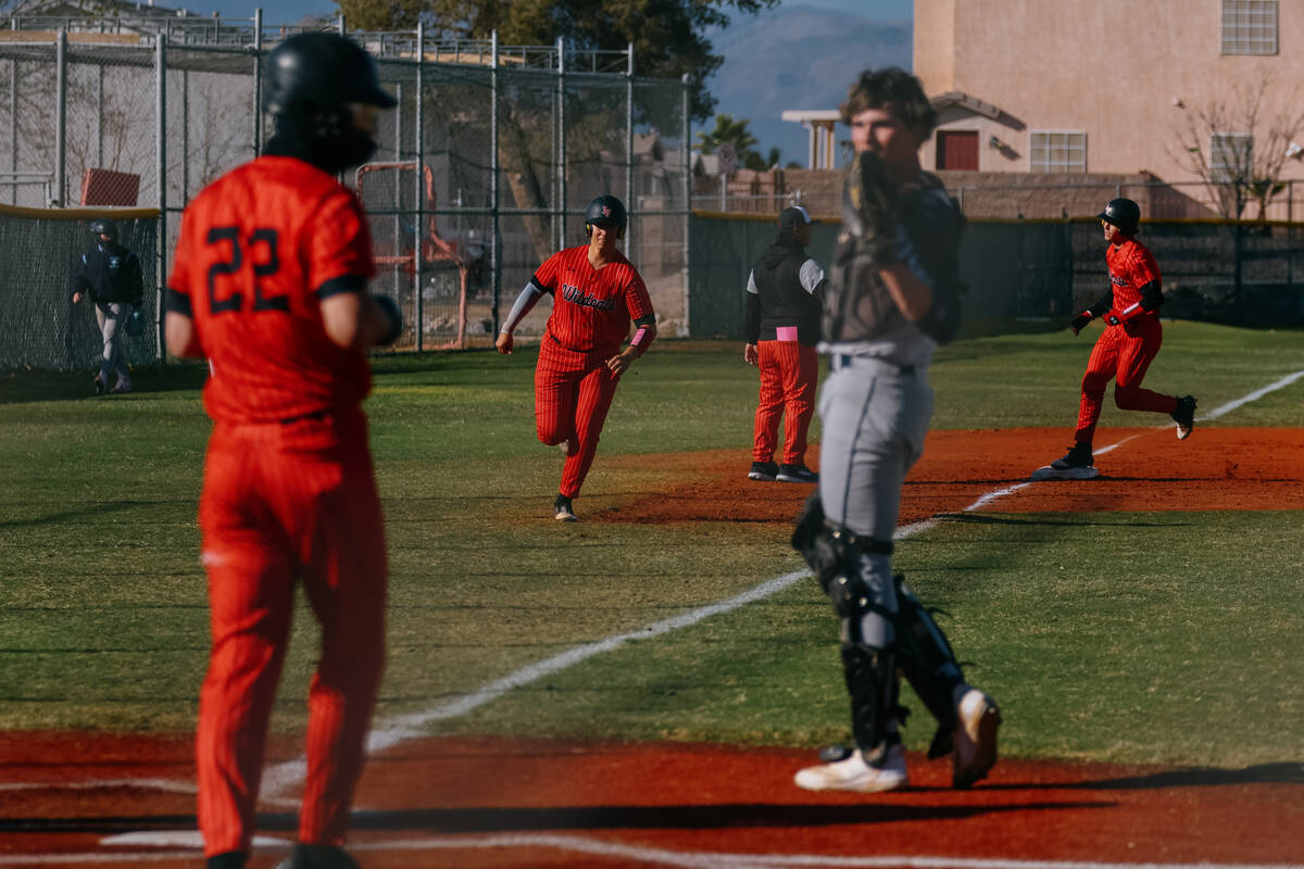 Multiple Las Vegas High players run to home plate after a grand slam against the Centennial Bul ...