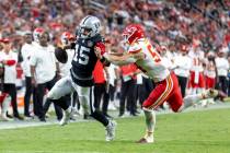 Raiders quarterback Gardner Minshew (15) is pushed out of bounds by Kansas City Chiefs lineback ...