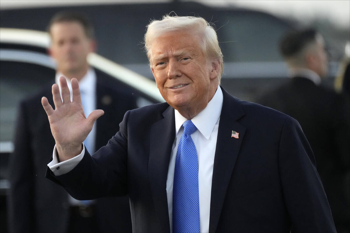 President Donald Trump waves after arriving on Air Force One at Palm Beach International Airpor ...