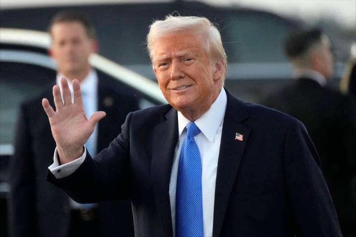 President Donald Trump waves after arriving on Air Force One at Palm Beach International Airpor ...