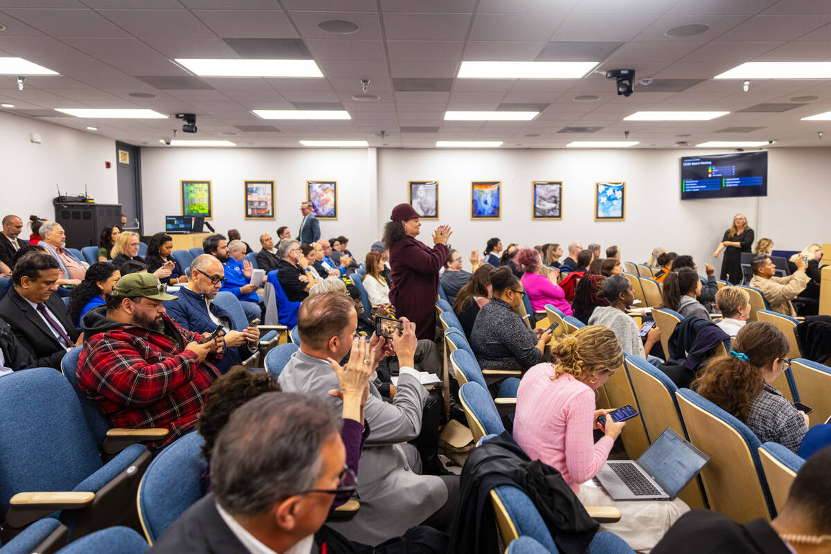 People cheer after the Clark County School Board of Trustees voted to select Jhone Ebert as the ...