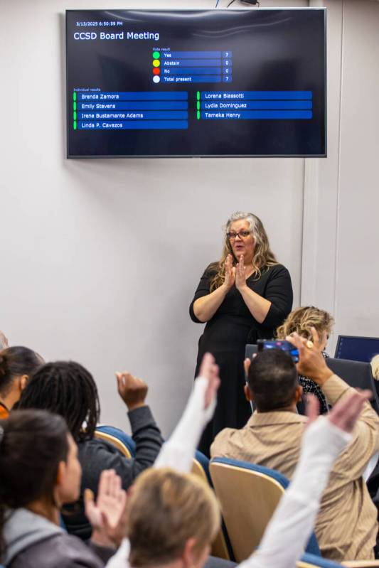 People cheer after the Clark County School Board of Trustees voted to select Jhone Ebert as the ...
