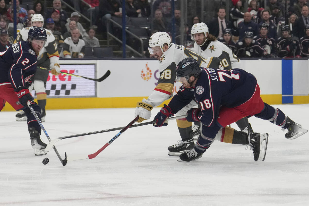 Vegas Golden Knights center Tomas Hertl (48) reaches for the puck with Columbus Blue Jackets de ...