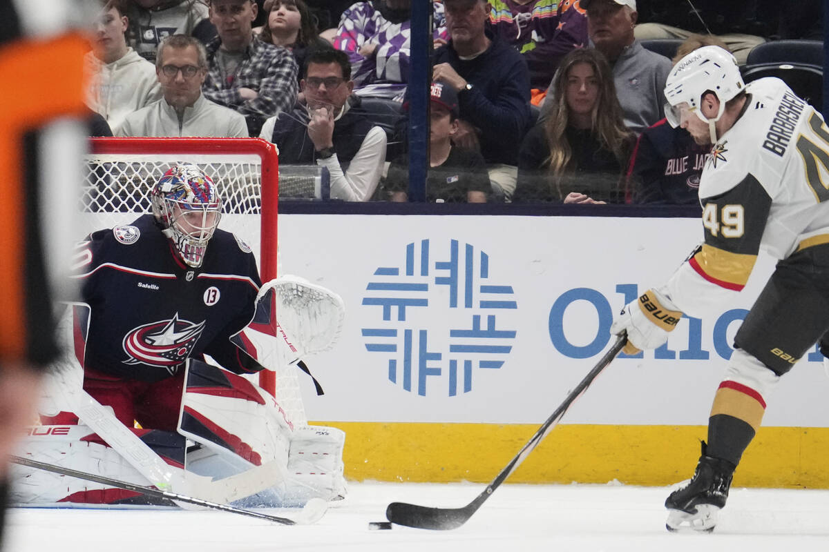 Vegas Golden Knights center Ivan Barbashev (49) shoots against Columbus Blue Jackets goaltender ...