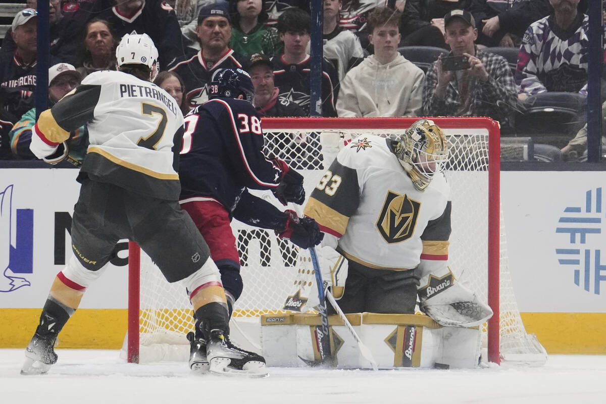 Vegas Golden Knights goaltender Adin Hill (33) blocks a shot by Columbus Blue Jackets center Bo ...