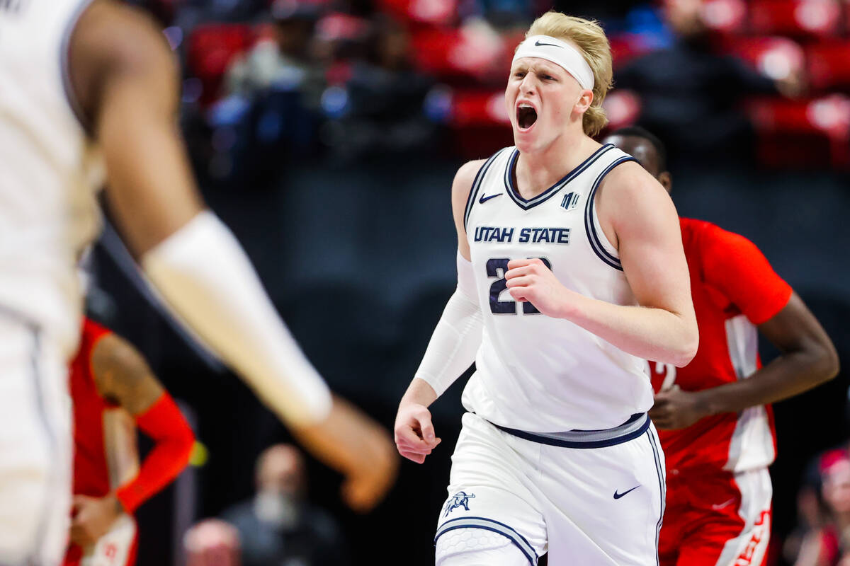 Utah State forward Karson Templin (22) cheers as he heads down the court during a Mountain West ...