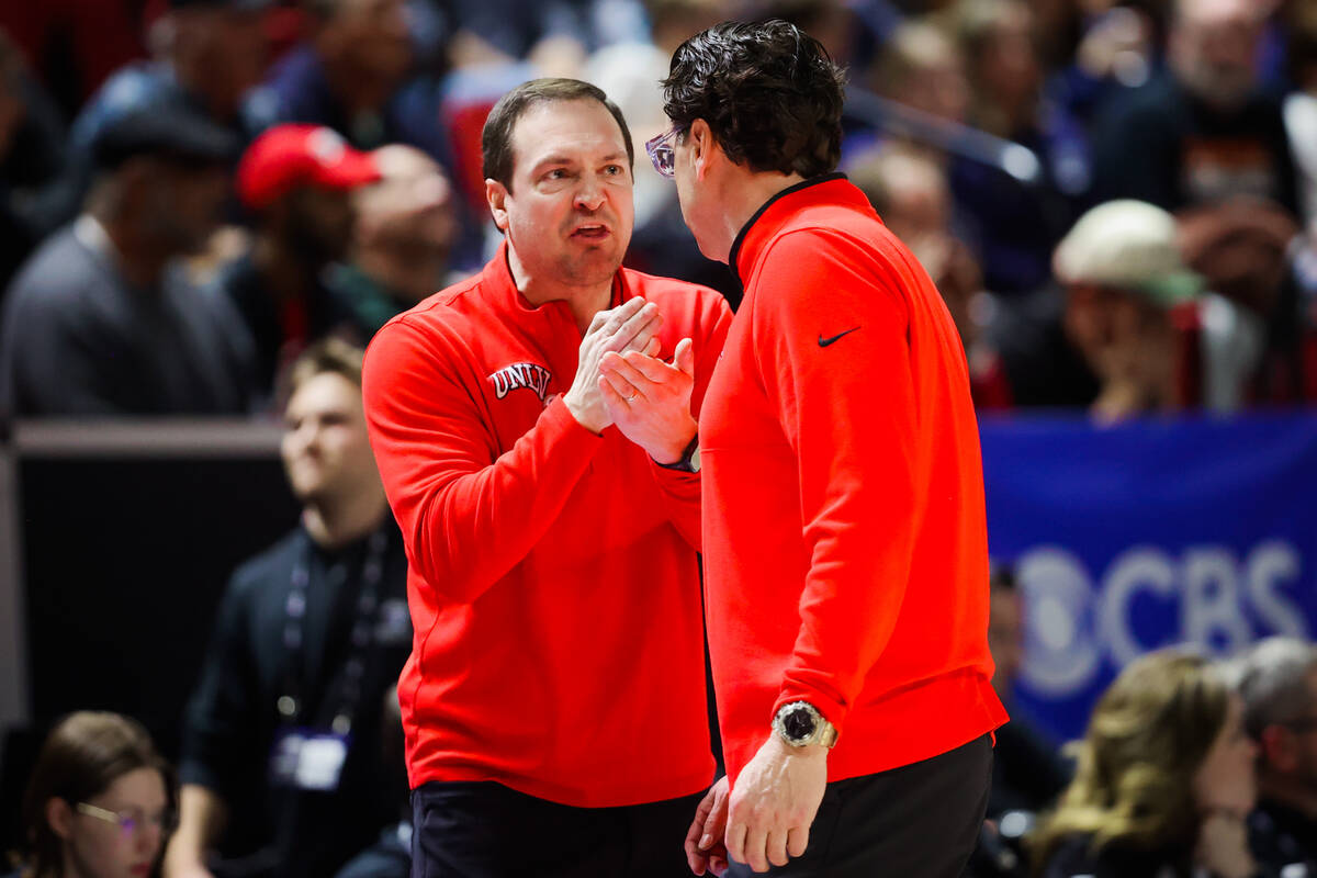 UNLV head coach Kevin Kruger, facing, yells to assistant coach Barret Peery after a foul on the ...