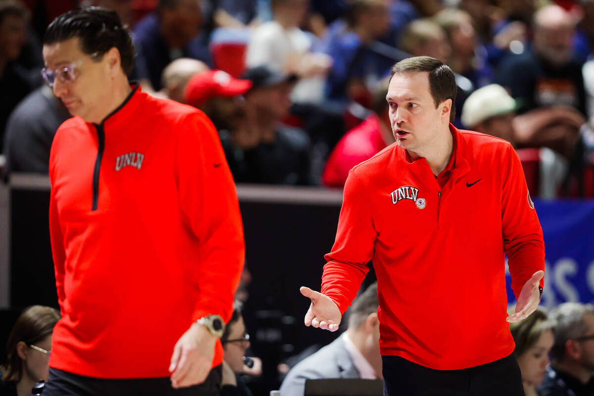 UNLV head coach Kevin Kruger, facing, yells to assistant coach Barret Peery after a foul on the ...