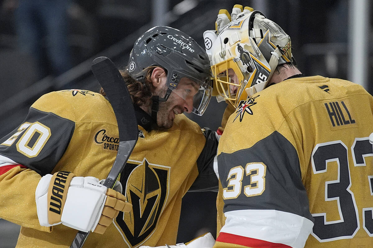 Vegas Golden Knights left wing Brandon Saad (20) and goaltender Adin Hill (33) celebrate after ...