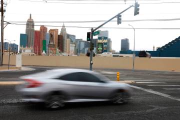 Motorists navigate Reno Avenue near its intersection with Giles Street Thursday, March 13, 2025 ...