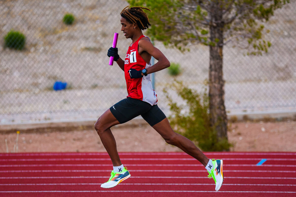 Desert Oasis runner Kenan Dagge finishes his last lap during a high school track and field meet ...