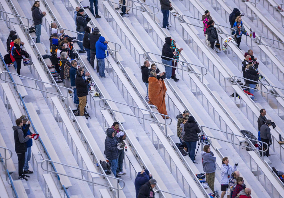 Fans attempt to stay warm during the NASCAR Craftsman Truck Series Ecosave 200 race at Las Vega ...