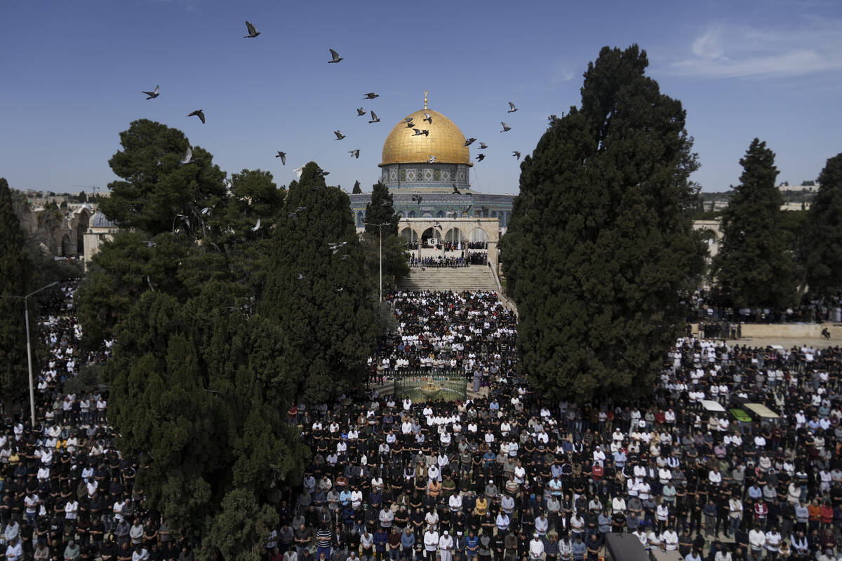 Palestinians perform Friday prayers at the Al-Aqsa Mosque compound in the Old City of Jerusalem ...