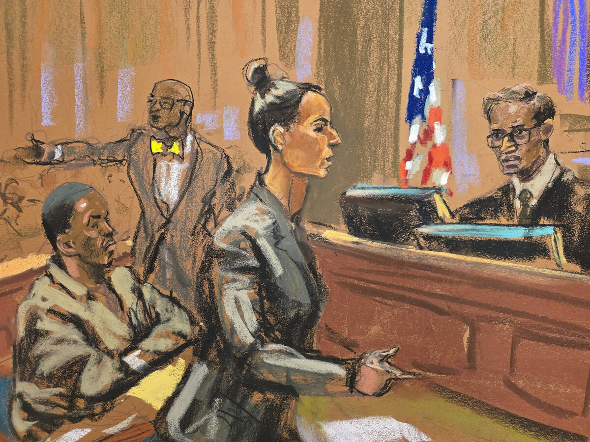In this courtroom sketch, Assistant United States Attorney Christy Slavic, standing center, spe ...