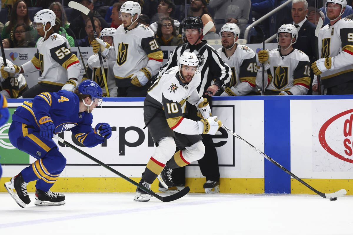 Vegas Golden Knights center Nicolas Roy (10) carries the puck past Buffalo Sabres defenseman Bo ...