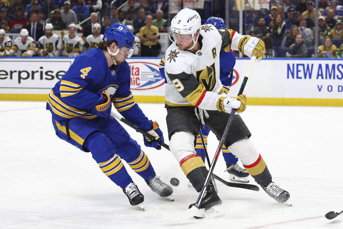 Buffalo Sabres defenseman Bowen Byram (4) takes the puck from Vegas Golden Knights center Jack ...