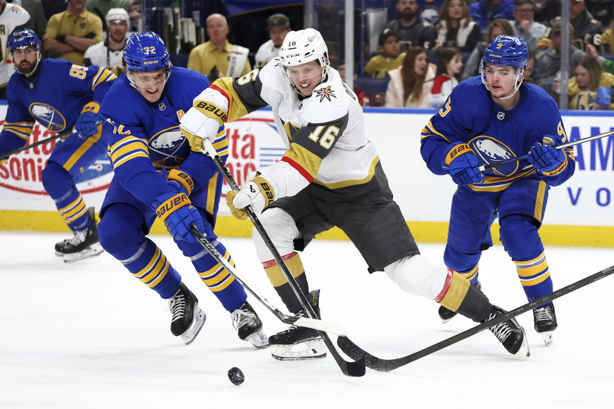 Vegas Golden Knights left wing Pavel Dorofeyev (16) is pressured by Buffalo Sabres center Tage ...