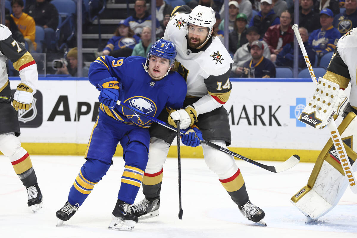 Buffalo Sabres left wing Zach Benson (9) and Vegas Golden Knights defenseman Nicolas Hague (14) ...