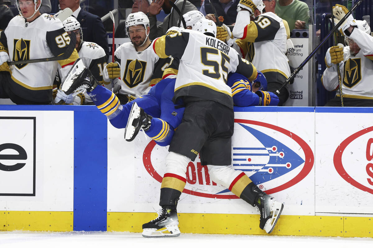 Vegas Golden Knights right wing Keegan Kolesar (55) checks Buffalo Sabres left wing Beck Malens ...