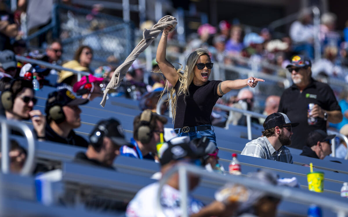Racing fan Bee Gramstad is pumped about the action on the circuit joined by husband Kyle during ...