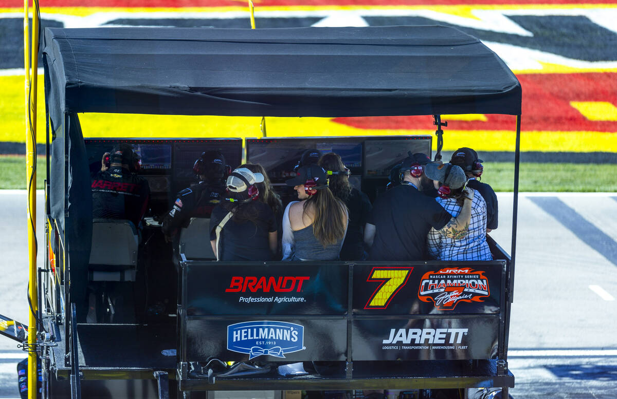A couple kisses while watching their driver Justin Allgaier (7) from a pit wagon as he leads th ...