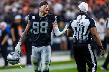 Raiders defensive end Maxx Crosby (98) chats with a referee during the second half of their NFL ...