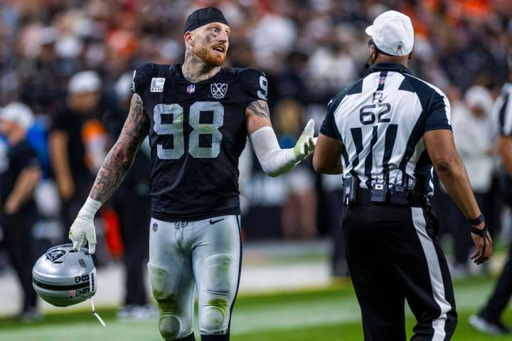 Raiders defensive end Maxx Crosby (98) chats with a referee during the second half of their NFL ...