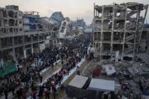 Surrounded by destroyed homes and buildings, Palestinians gather for iftar, the fast-breaking m ...