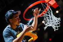 Colorado State Rams guard Darnez Slater (3) cuts down a piece of the net after winning the Moun ...