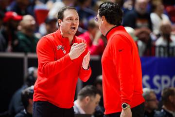 UNLV head coach Kevin Kruger, facing, yells to assistant coach Barret Peery after a foul on the ...