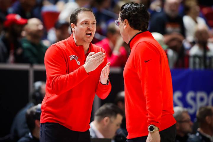 UNLV head coach Kevin Kruger, facing, yells to assistant coach Barret Peery after a foul on the ...