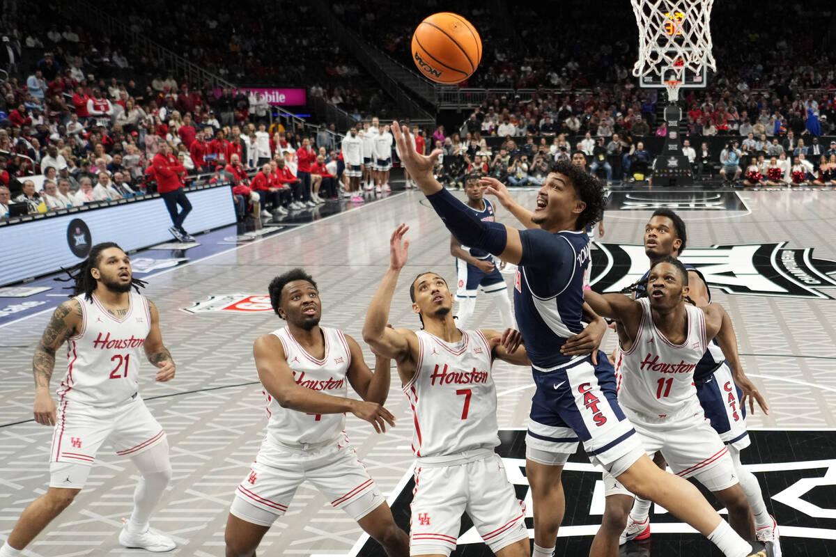 Arizona guard KJ Lewis (5) puts up a shot during the first half of an NCAA college basketball g ...