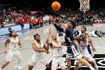 Arizona guard KJ Lewis (5) puts up a shot during the first half of an NCAA college basketball g ...