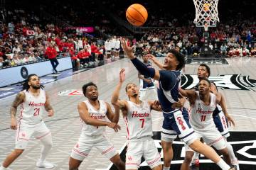 Arizona guard KJ Lewis (5) puts up a shot during the first half of an NCAA college basketball g ...