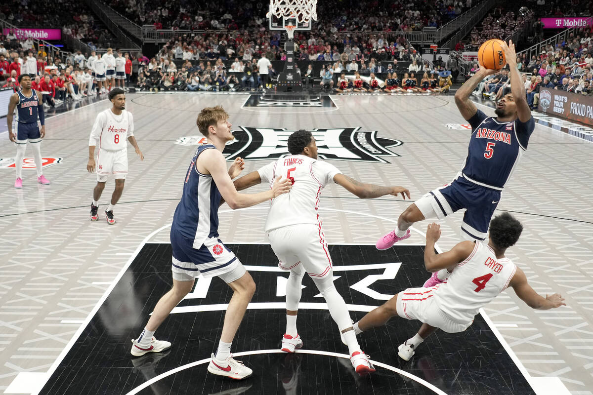 Arizona guard KJ Lewis (5) puts up a shot during the first half of an NCAA college basketball g ...