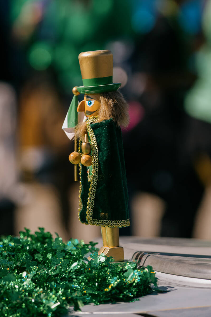 A nutcracker sits on the back end of a car going down Water Street during the annual St. Patric ...