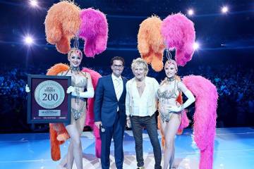 Rod Stewart is shown with Sean McBurney, regional president of Caesars Entertainment, and Vegas ...