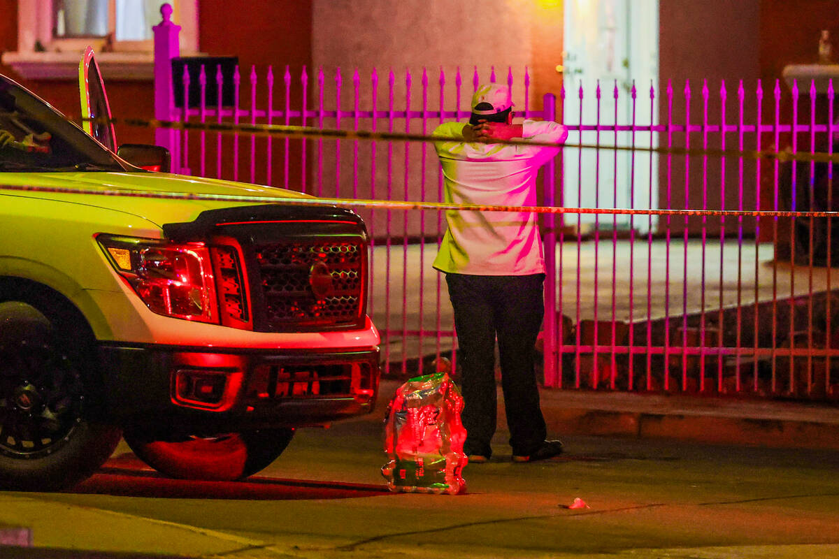 Mourners gather near a homicide scene on the 700 block of Bruce Street Saturday, March 15, 2025 ...