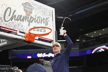 UC San Diego head coach Eric Olen participates in a net-cutting ceremony after an NCAA college ...
