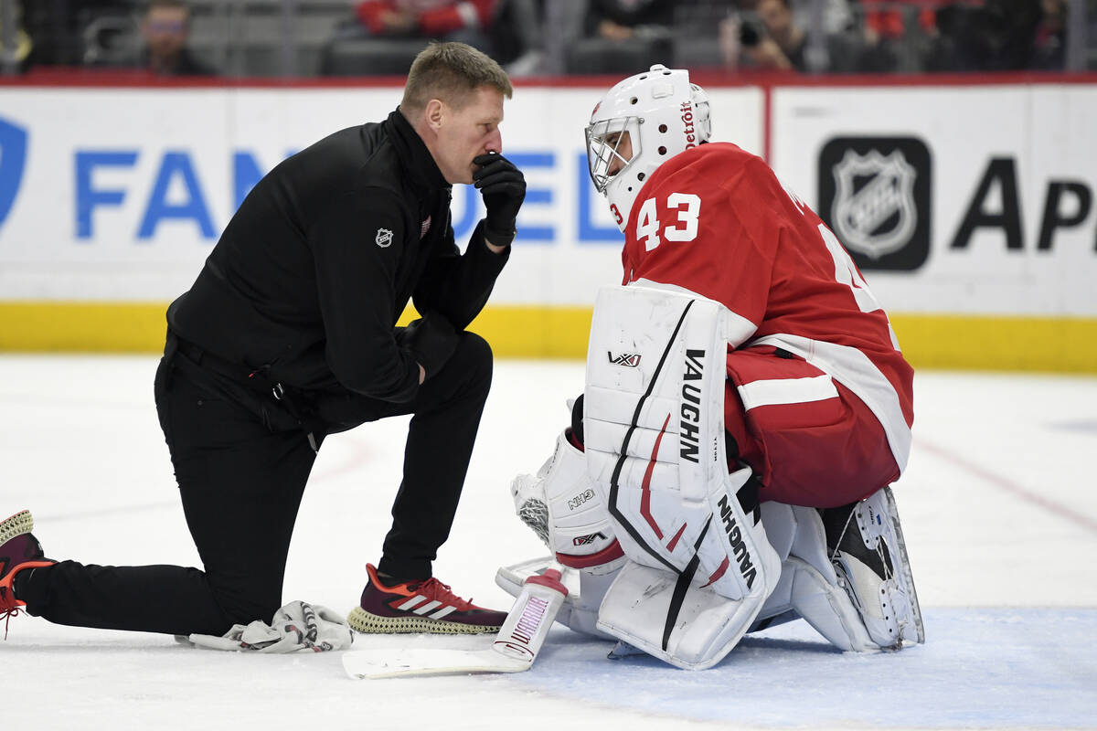 Detroit Red Wings head athletic trainer Piet Van Zant, left, talks with goaltender Petr Mrazek ...