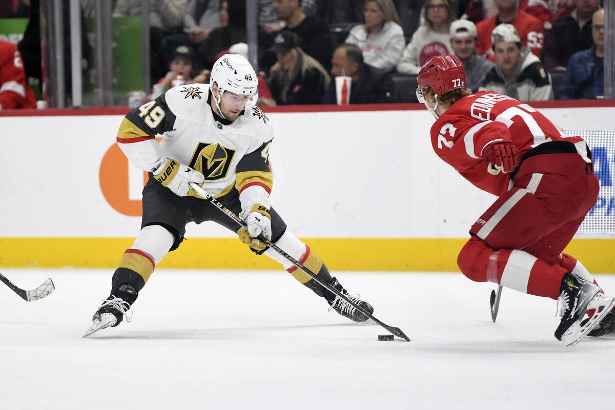 Vegas Golden Knights center Ivan Barbashev, left, skates with the puck as he is chased by Detro ...