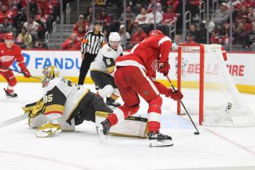 Detroit Red Wings defenseman Albert Johansson, right, skates past Vegas Golden Knights goaltend ...