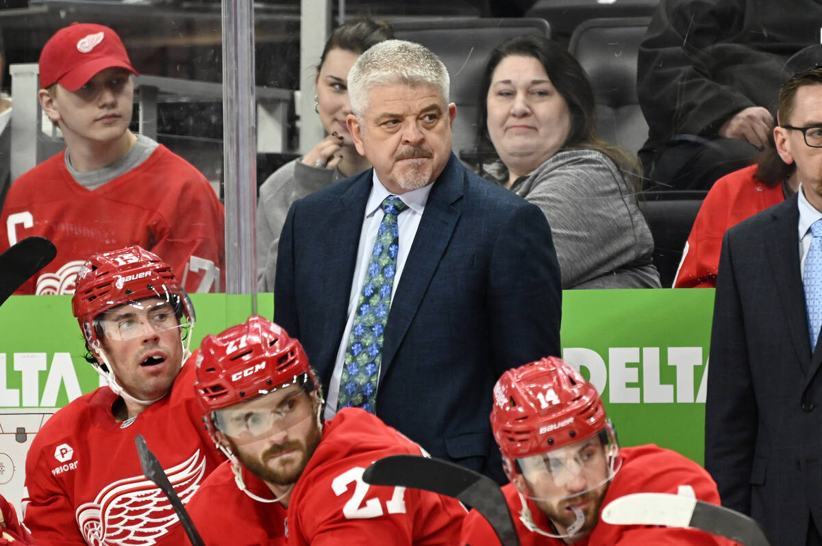 Detroit Red Wings head coach Todd McLellan, standing, watches during the first period of an NHL ...